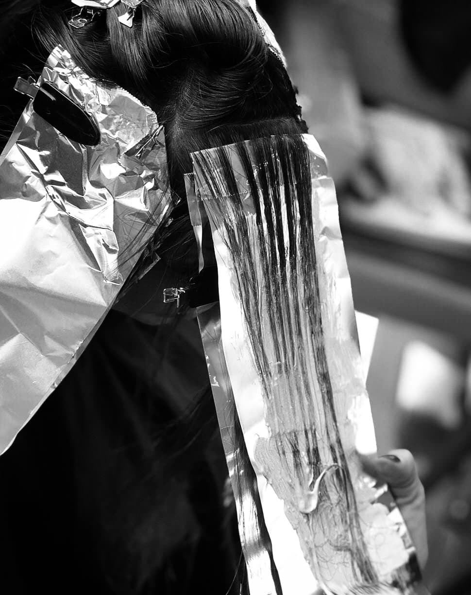 Highlight foils being applied to a section of hair